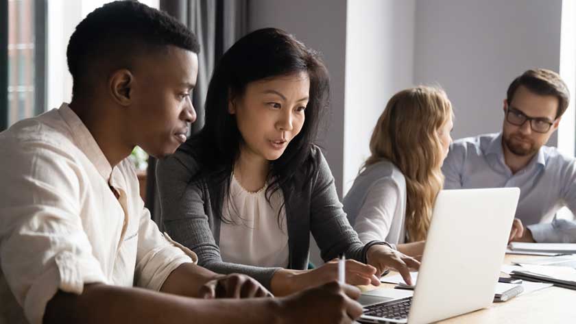 employees downloading outsourcing guide on their computer